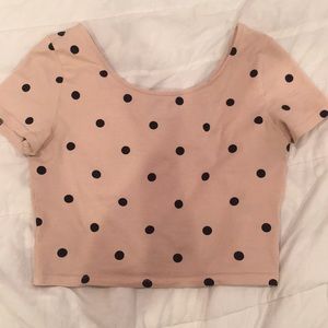 Light pink crop top with black poka dots.